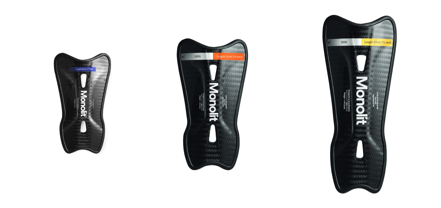 carbon fibre shin guards with 'Monolit' branding on a white background